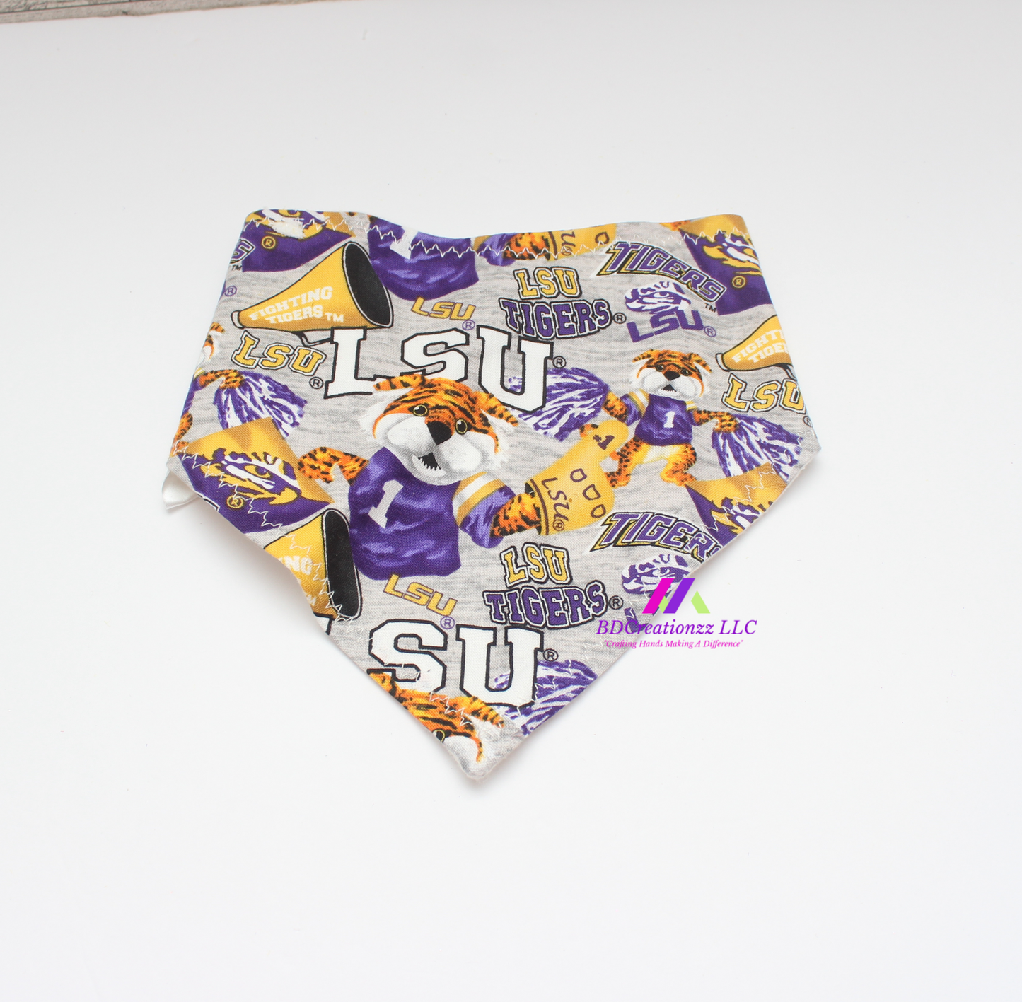 Matching football print burp cloth in purple, gold and white.