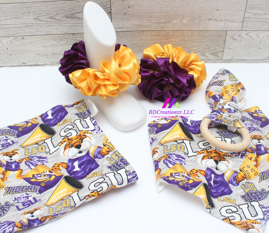 Purple and gold football baby gift set with bib, burp cloth, teether, beanie hat and matching detachable ruffle socks handmade by BDCreationzz.