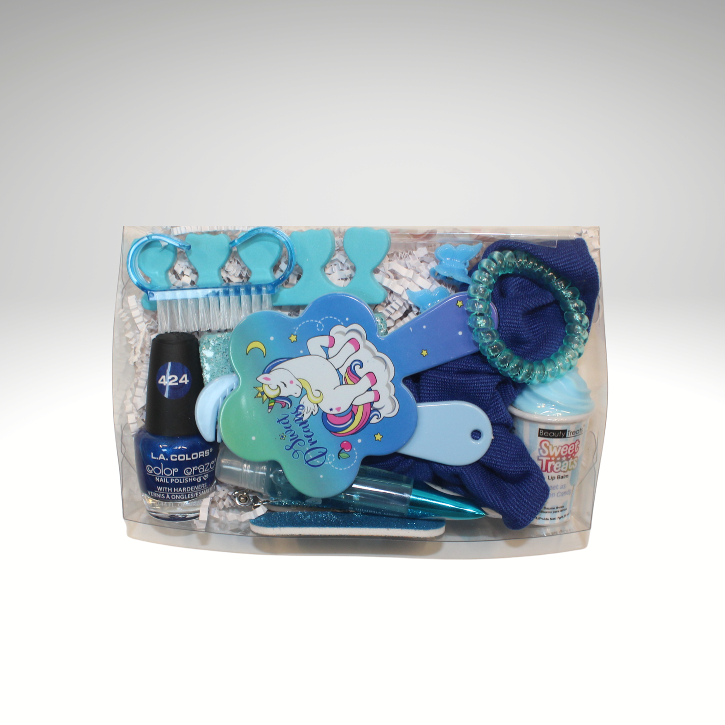 Packaged set of blue nail care and hair accessories on a white background