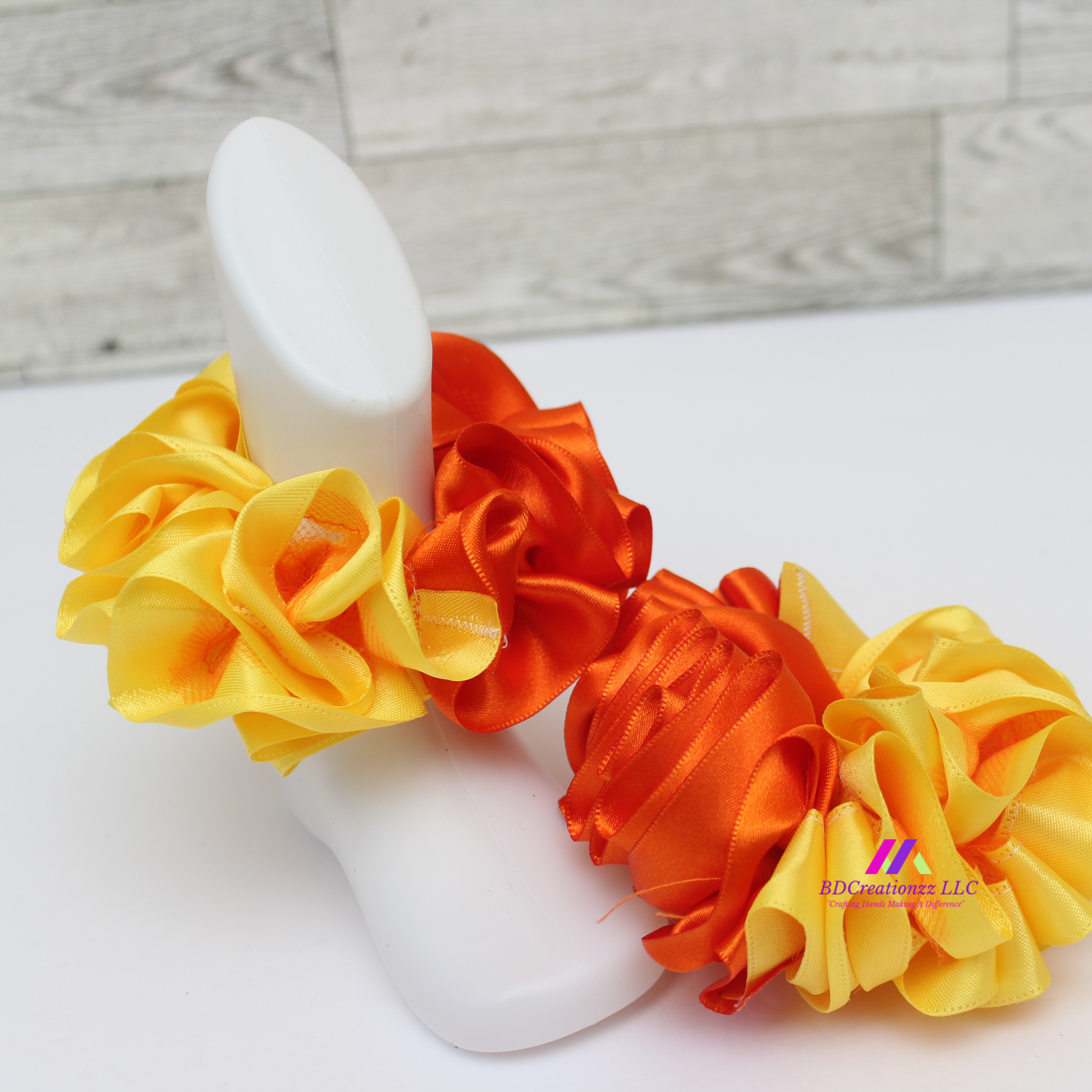 Side view of baby socks with detachable ruffles in orange and yellow, comfortable and stylish